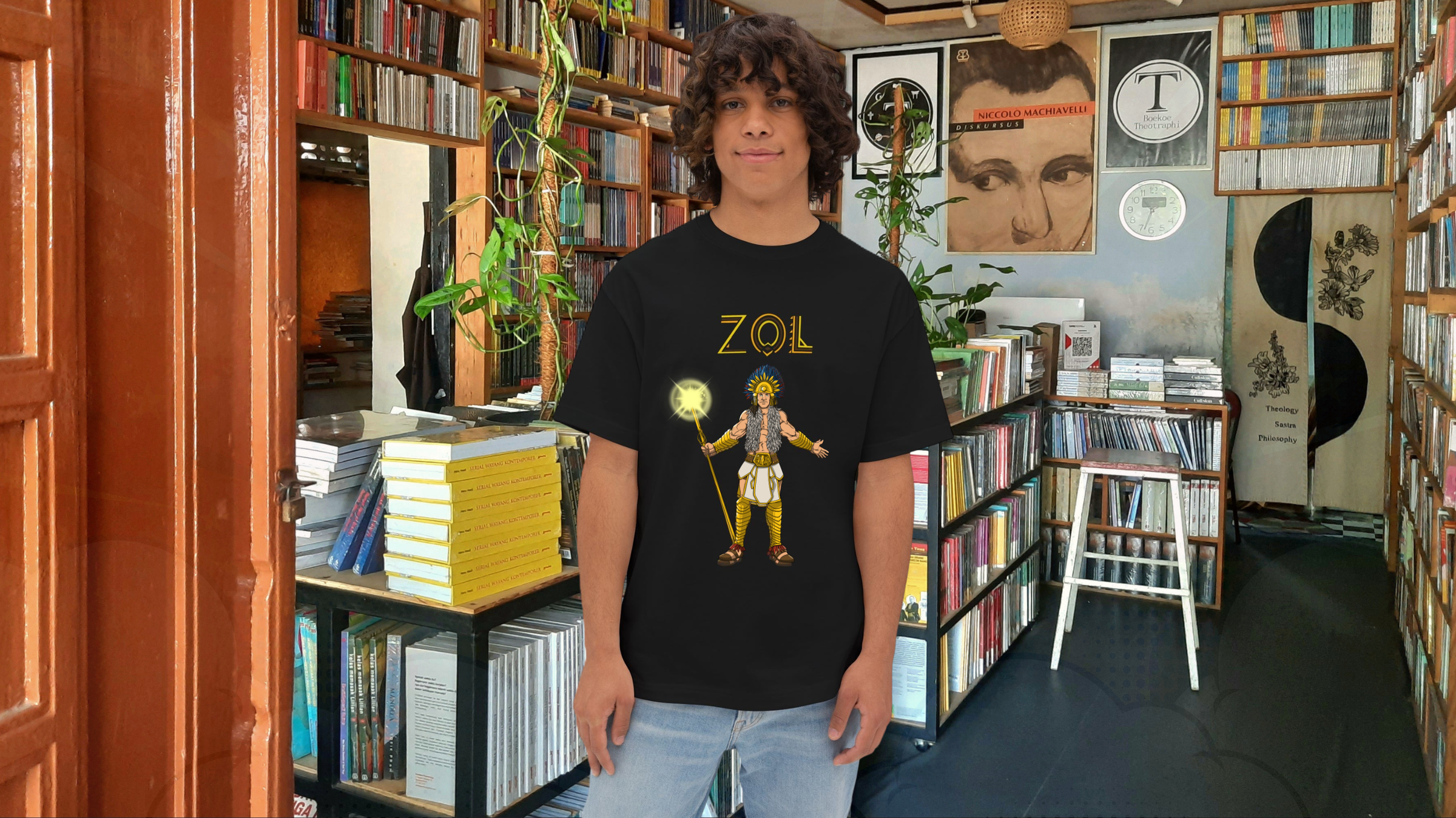 Person wearing a black t-shirt with a graphic design in a bookstore